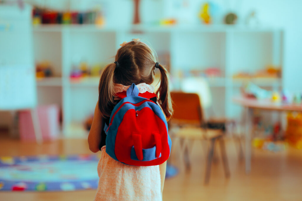 Parent comforting young child with school anxiety before preschool drop-off