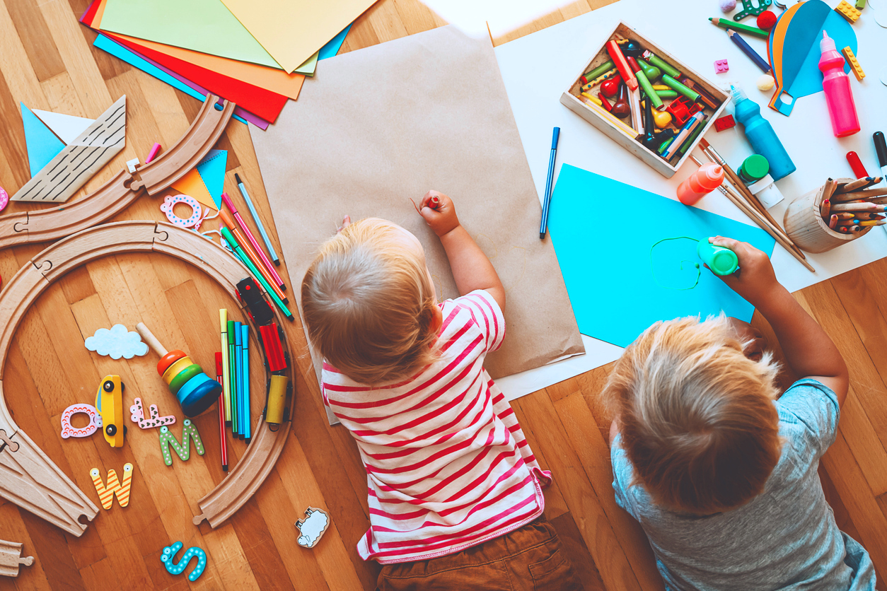 Kids drawing and crafting with educational toys in learning activities for preschool creativity and motor skills.