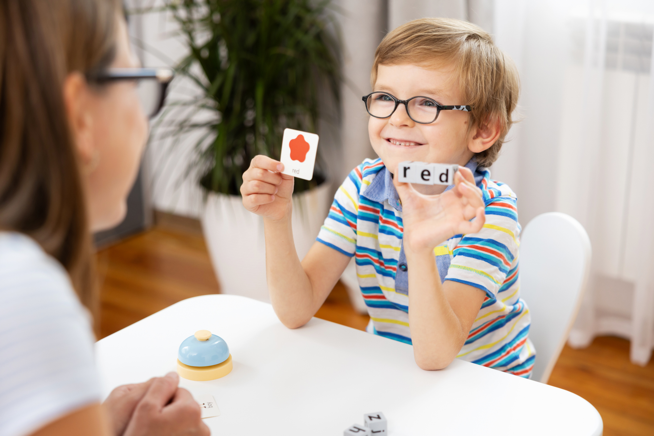 Child building CVC words with letter cards during a playful phonics activity for early reading