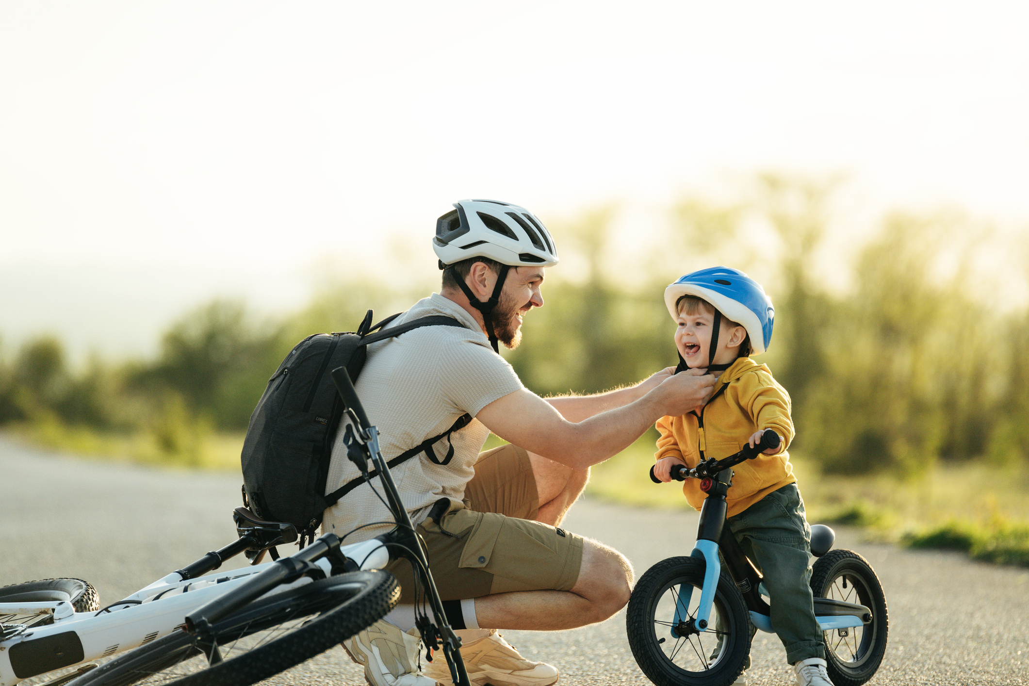 child practicing safe risky play by climbing outdoors while a parent supervises nearby